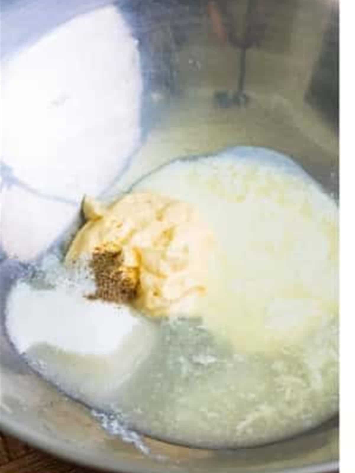 Dressing ingredients whisked together in a bowl for KFC coleslaw.