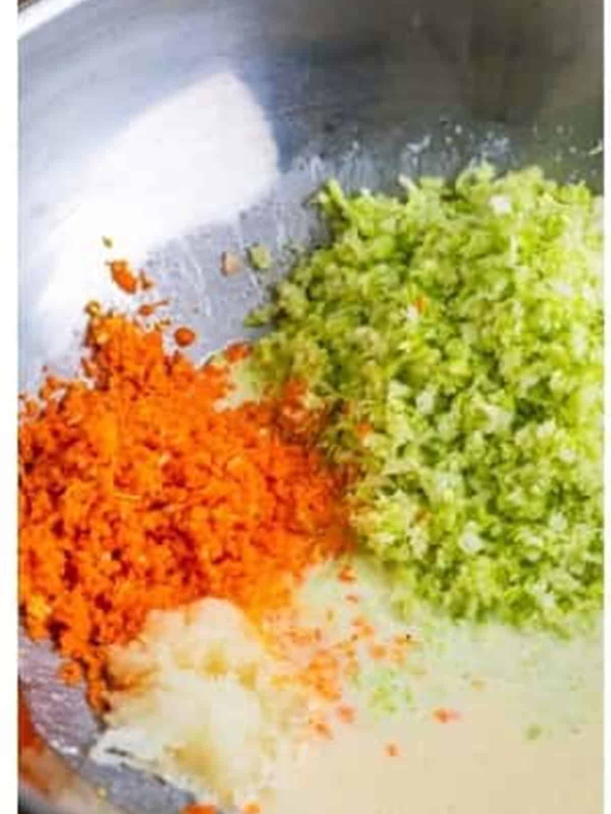 Chopped cabbage, carrots, and onion added to the dressing bowl.