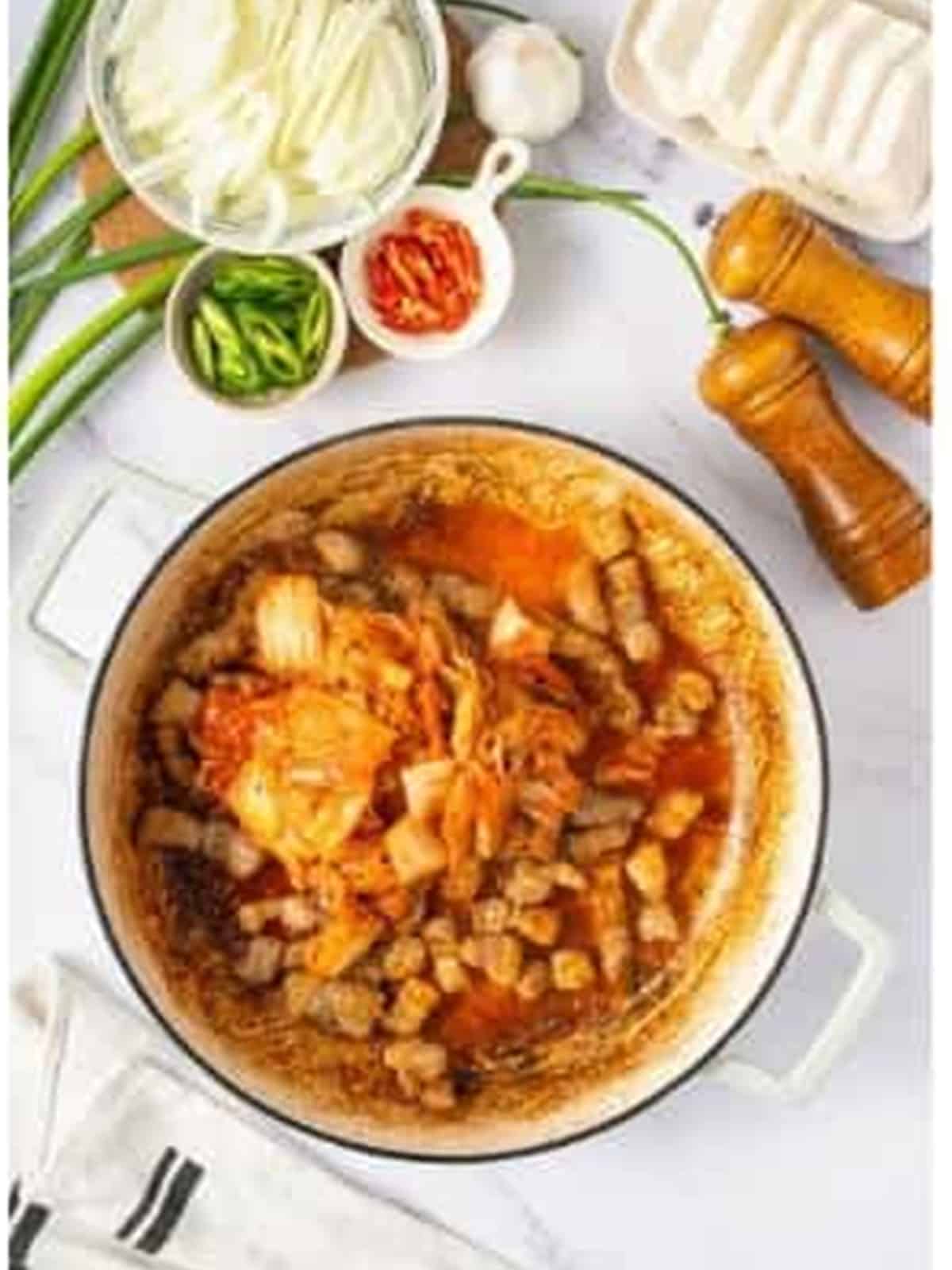 Marinated pork belly stir-fried with kimchi in a pot.