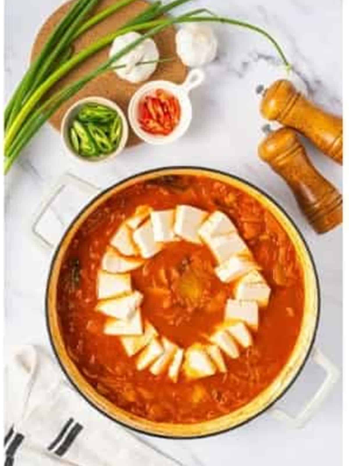 Soft tofu added to the simmering kimchi jjigae stew.