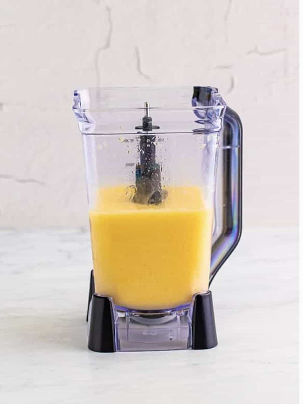 Mango mixture blended completely smooth in a blender for the Kiss on the Lips drink.