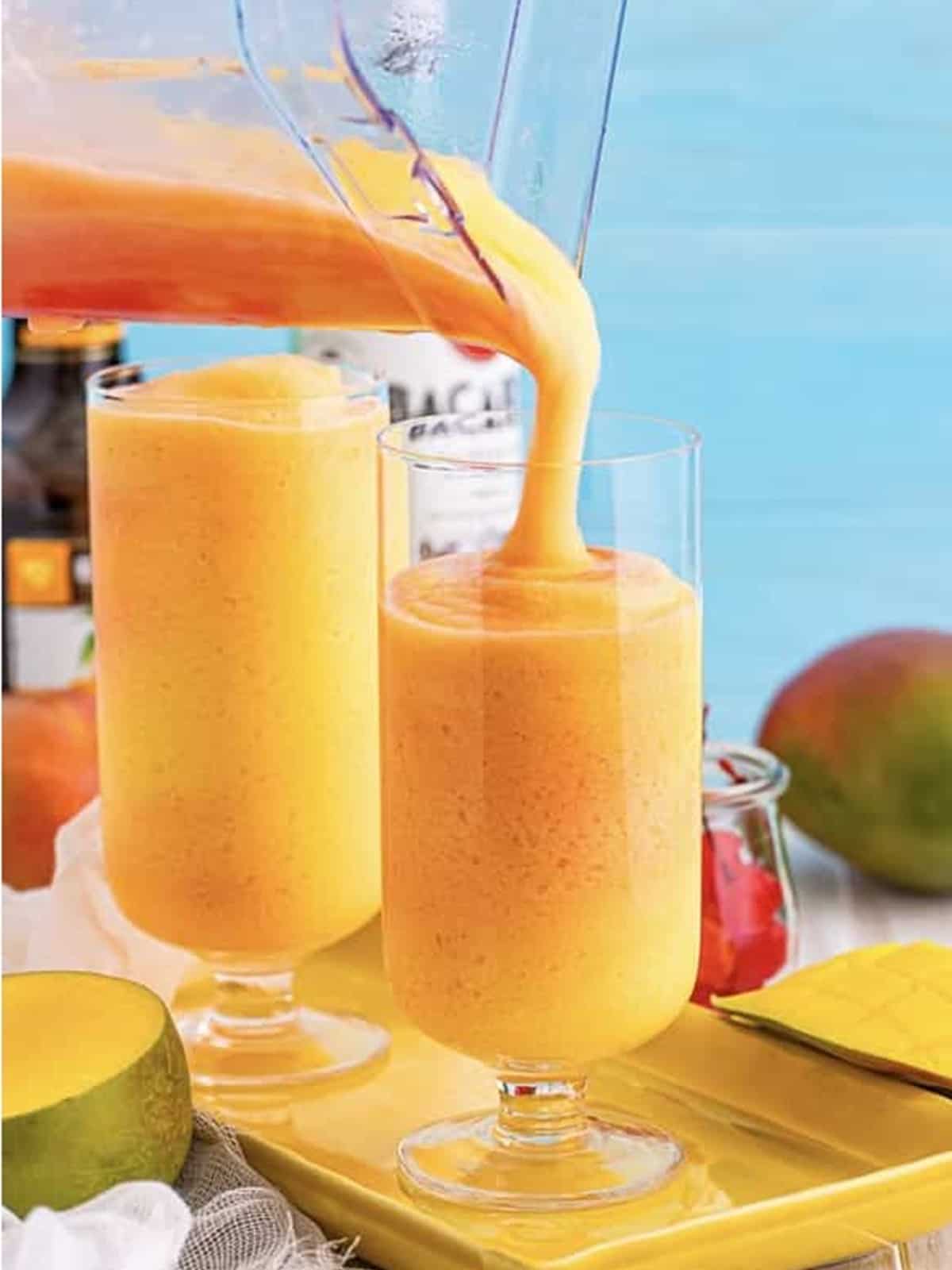 Frozen Kiss on the Lips drink poured into tall glasses garnished with cherries.