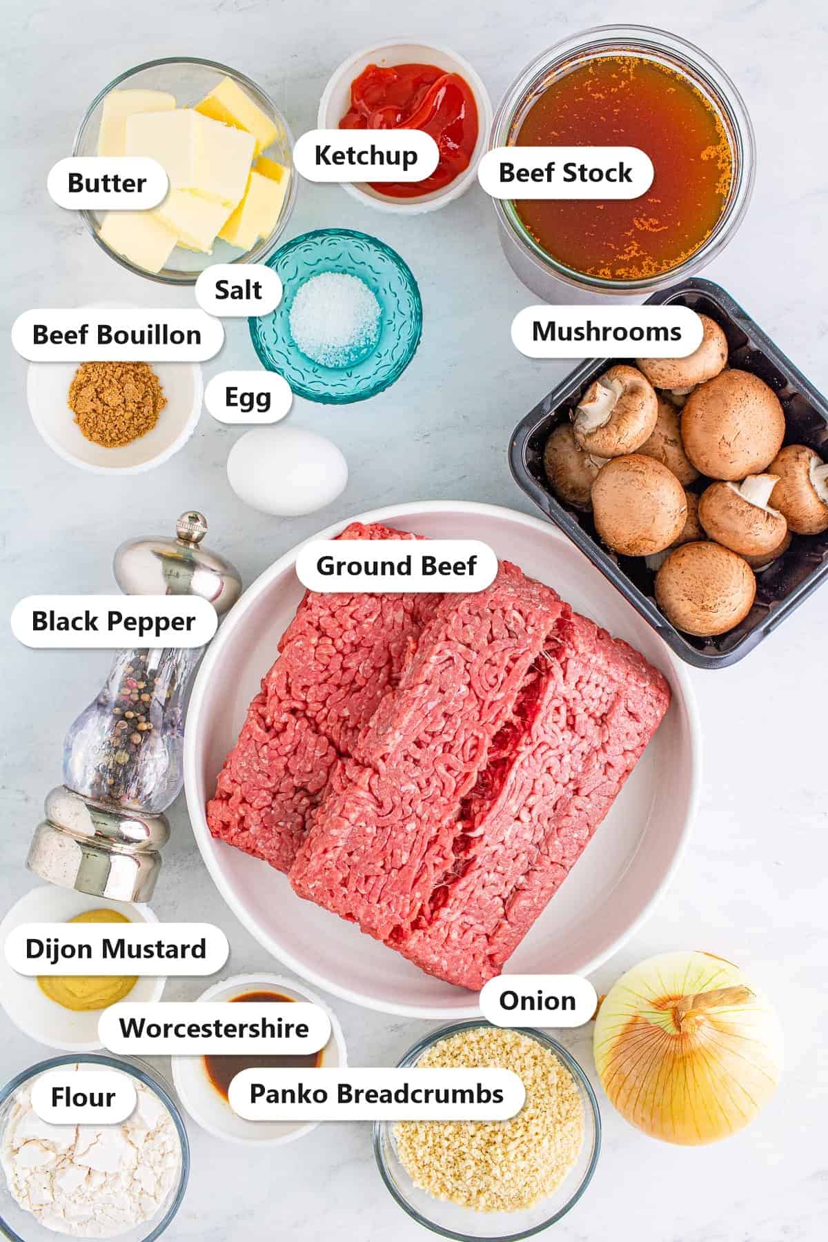 Labeled ingredients to make salisbury steak including ground beef, mushrooms, beef stock, onion, butter, and seasonings.