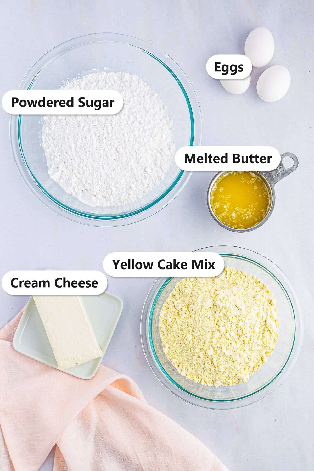 Labeled Gooey Butter Cake ingredients including yellow cake mix, cream cheese, powdered sugar, melted butter, and eggs.