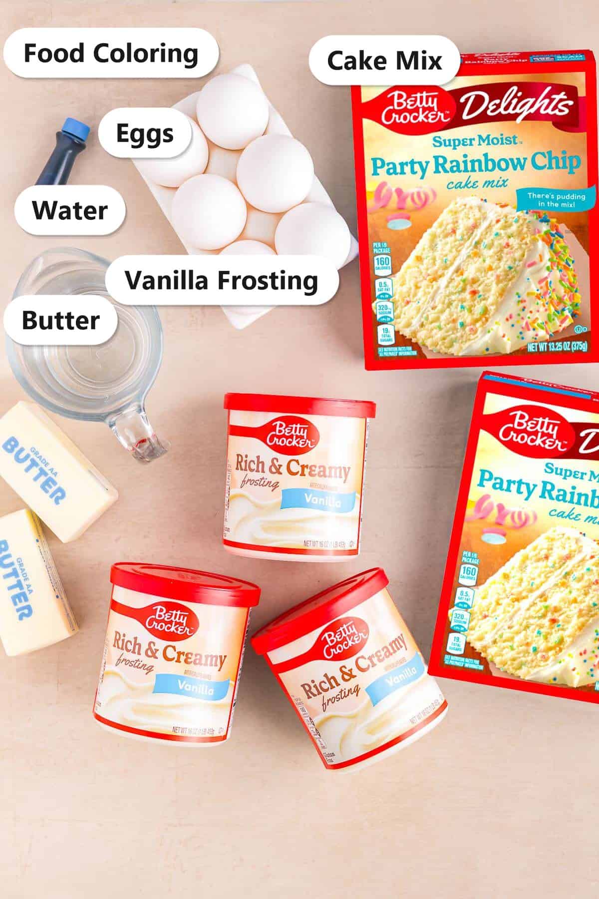 Labeled ingredients for a smash cake including cake mix, vanilla frosting, butter, eggs, water, and food coloring.
