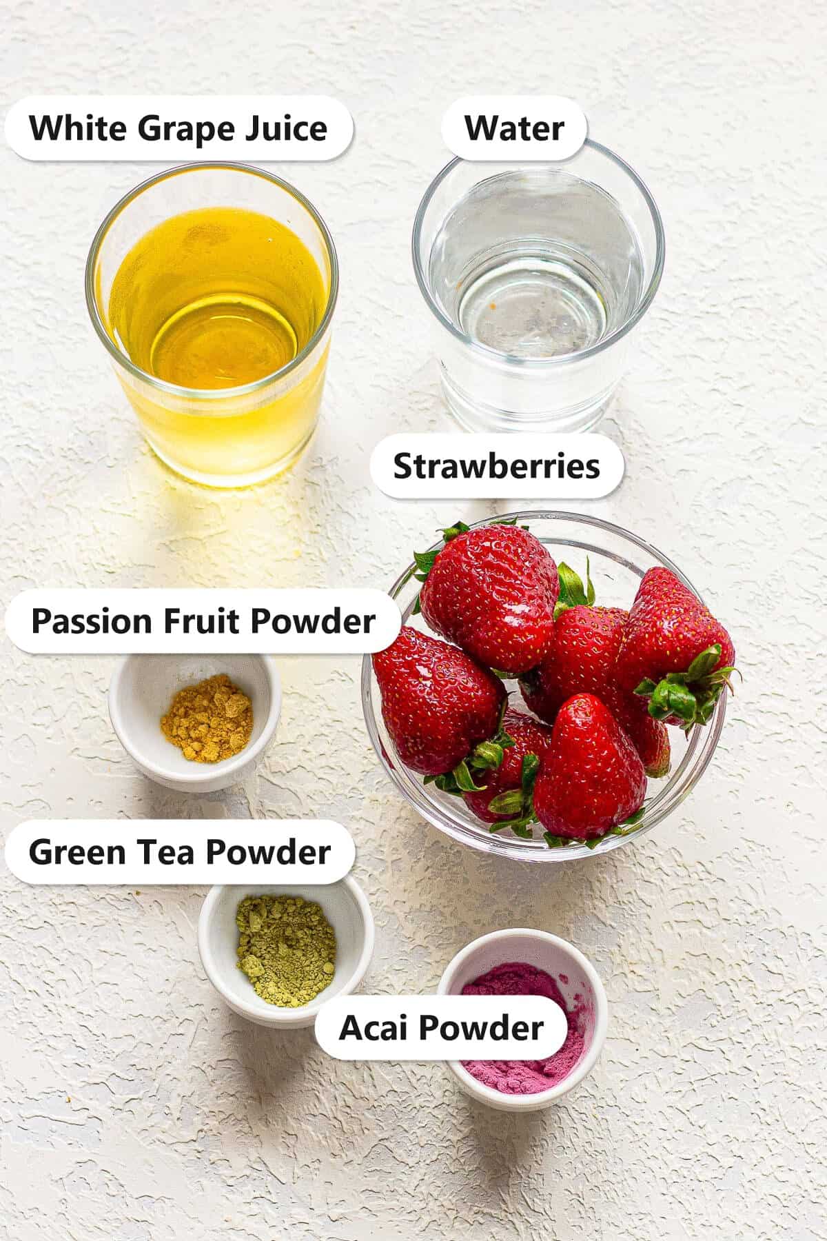 Labeled Strawberry Acai Refresher ingredients including acai powder, green tea powder, passion fruit powder, water, white grape juice, and fresh strawberries.