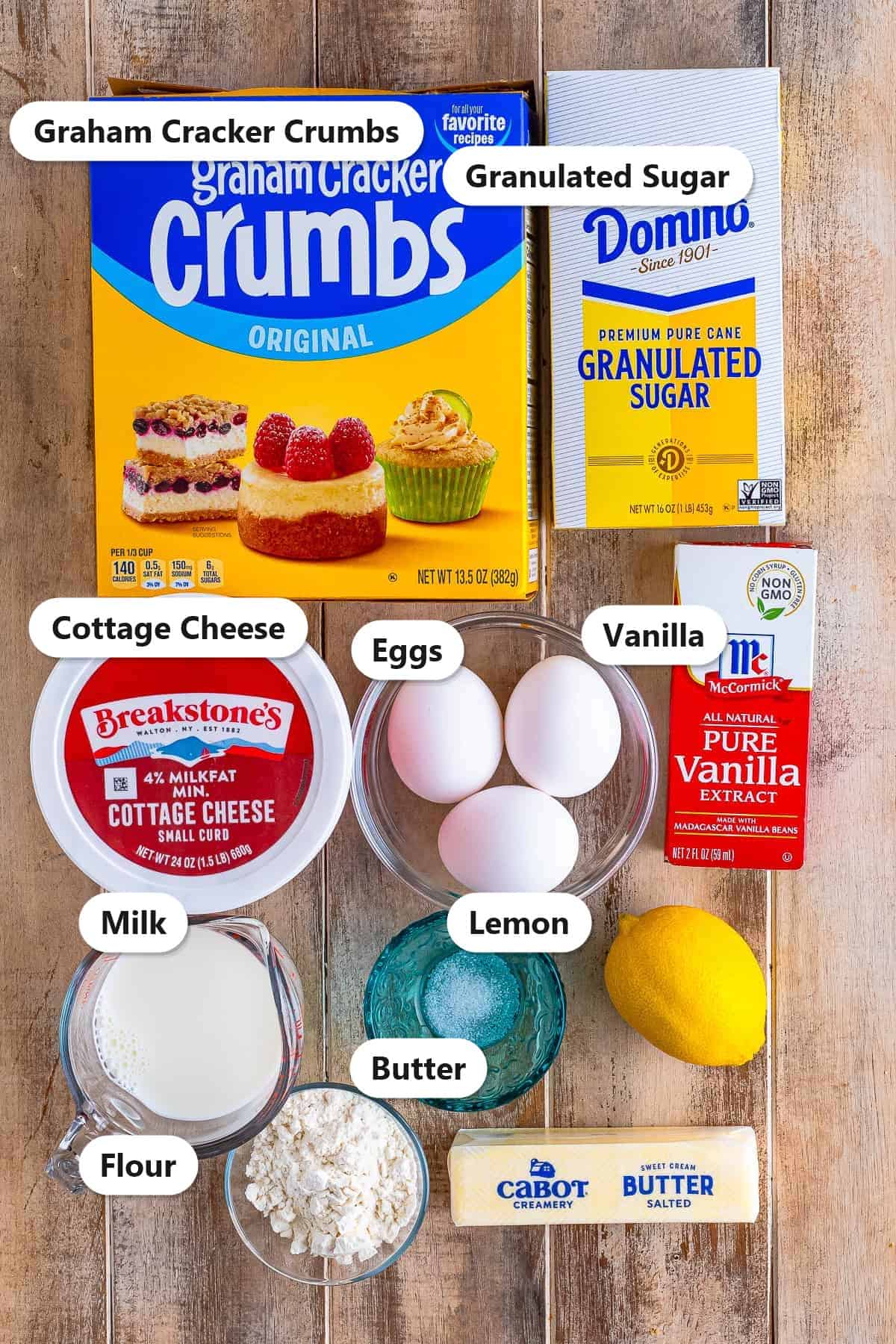 Labeled Cottage Cheese Cake ingredients including cottage cheese, graham cracker crumbs, sugar, eggs, milk, butter, flour, lemon, and vanilla.