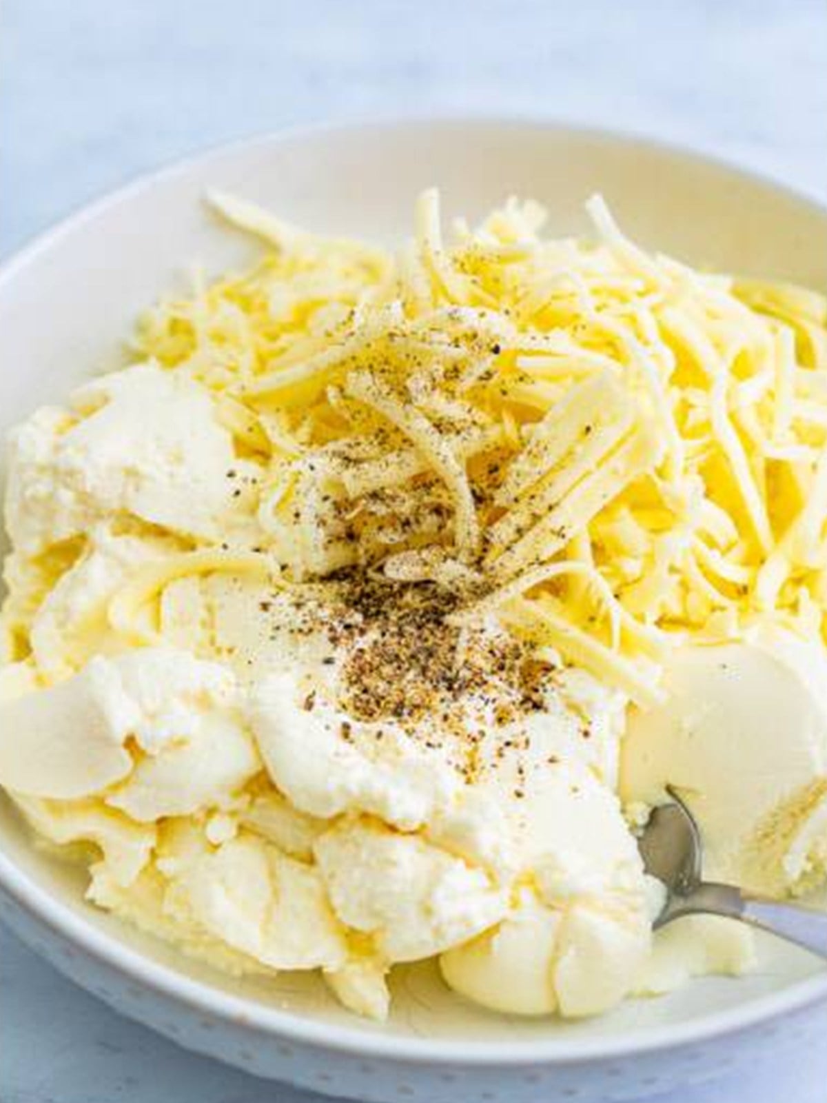 Ricotta, mozzarella, and pepper combined in a bowl for Lasagna Soup.