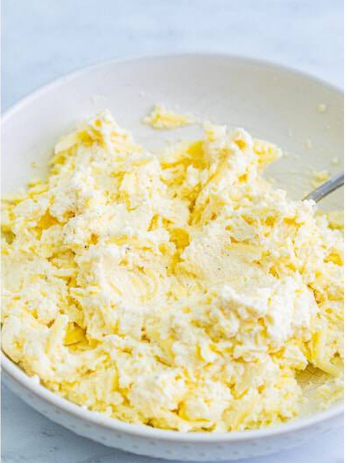 Creamy ricotta cheese mixture stirred for the Lasagna Soup topping.