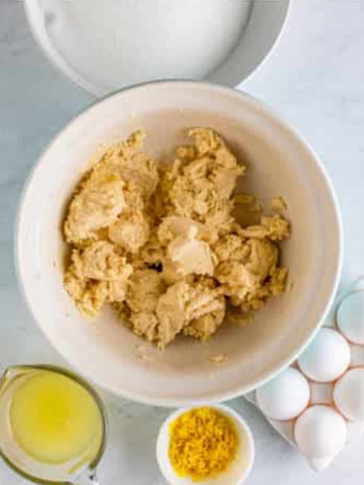 Shortbread crust dough mixed in a bowl for lemon bars.