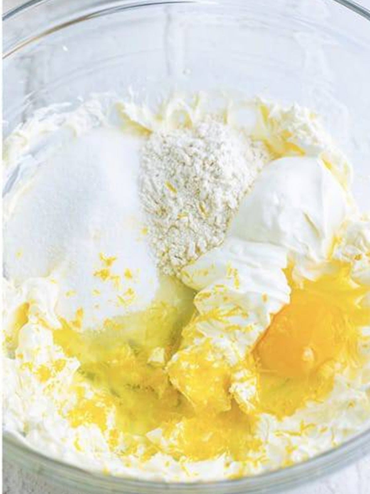 Sour cream, sugar, egg, lemon juice, and zest added to the cream cheese for the cheesecake batter.