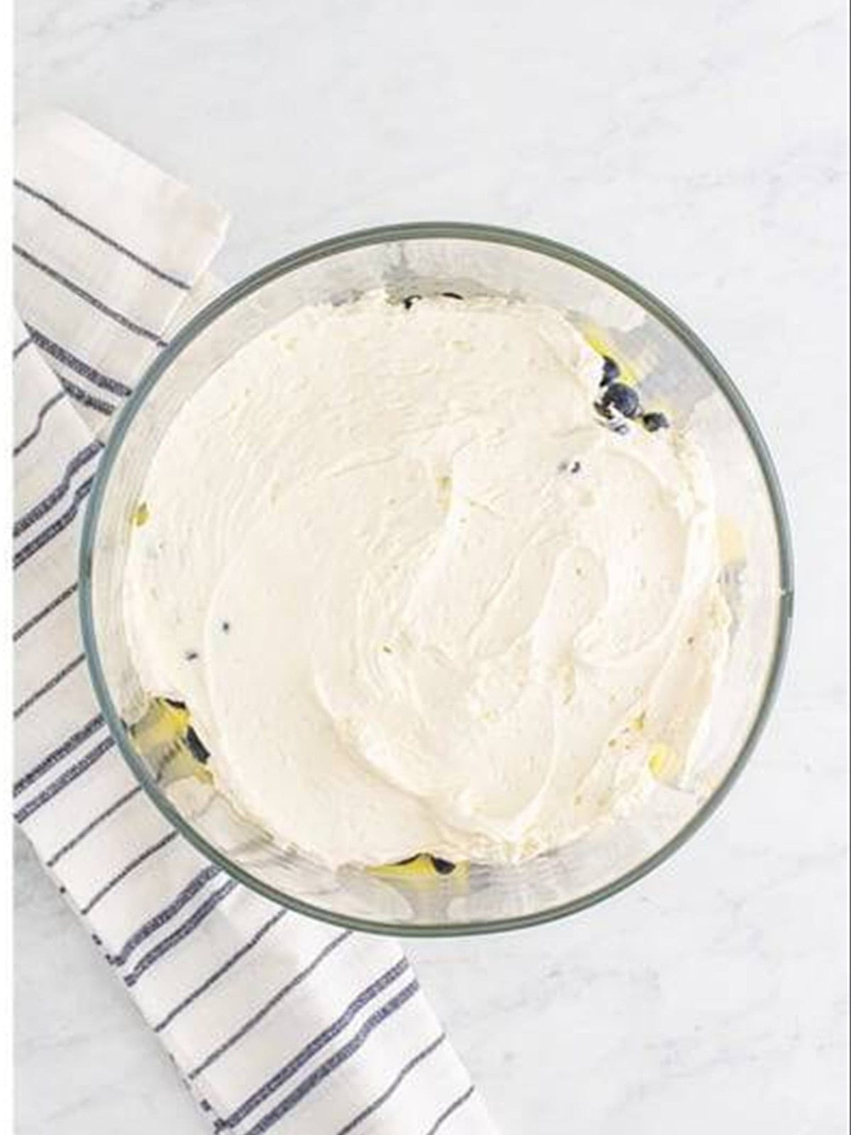 Lemon whipped topping layered over the blueberries in the trifle.