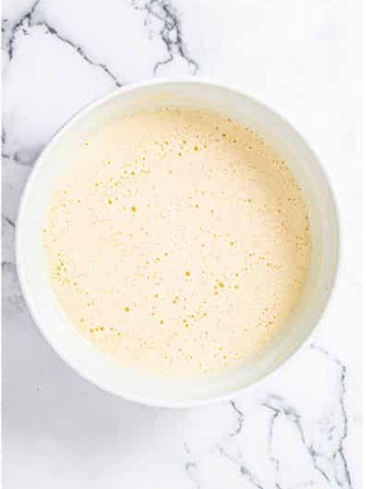 Adding the dry ingredients to the wet lemon bread batter.