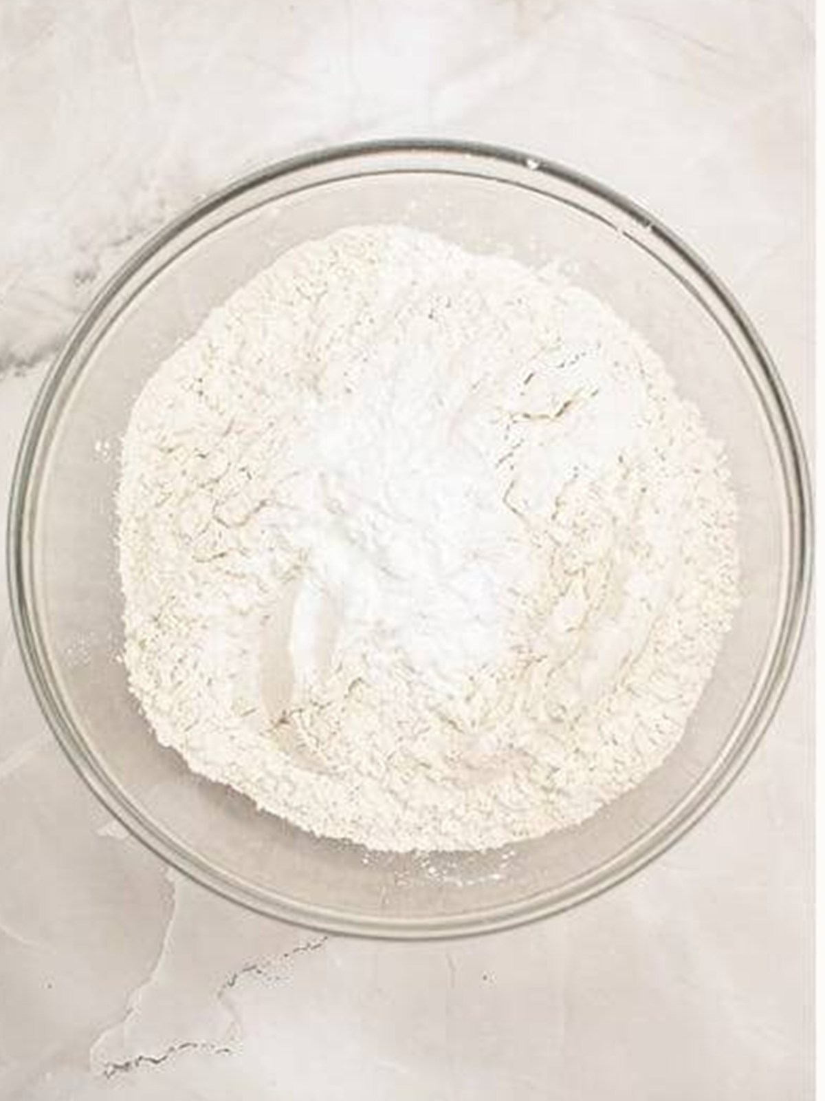 Mixing the dry ingredients for lemon bundt cake in a bowl.