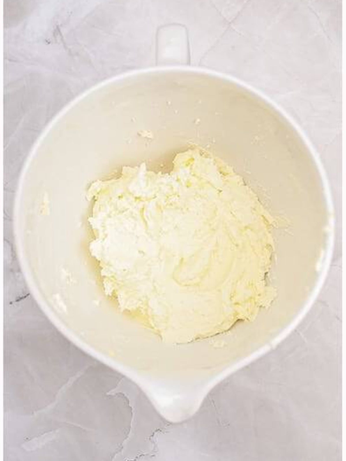 Creaming butter and sugar in a stand mixer bowl.