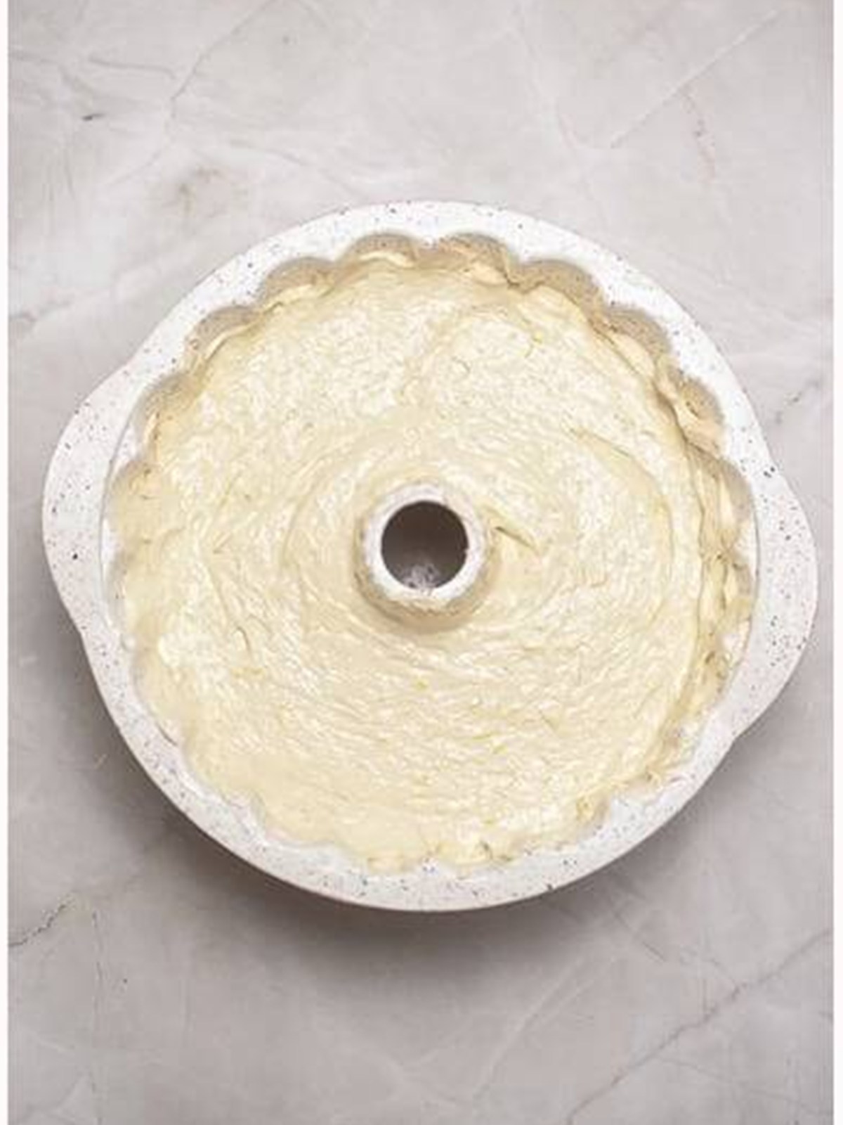 Lemon cake batter poured into a bundt pan.