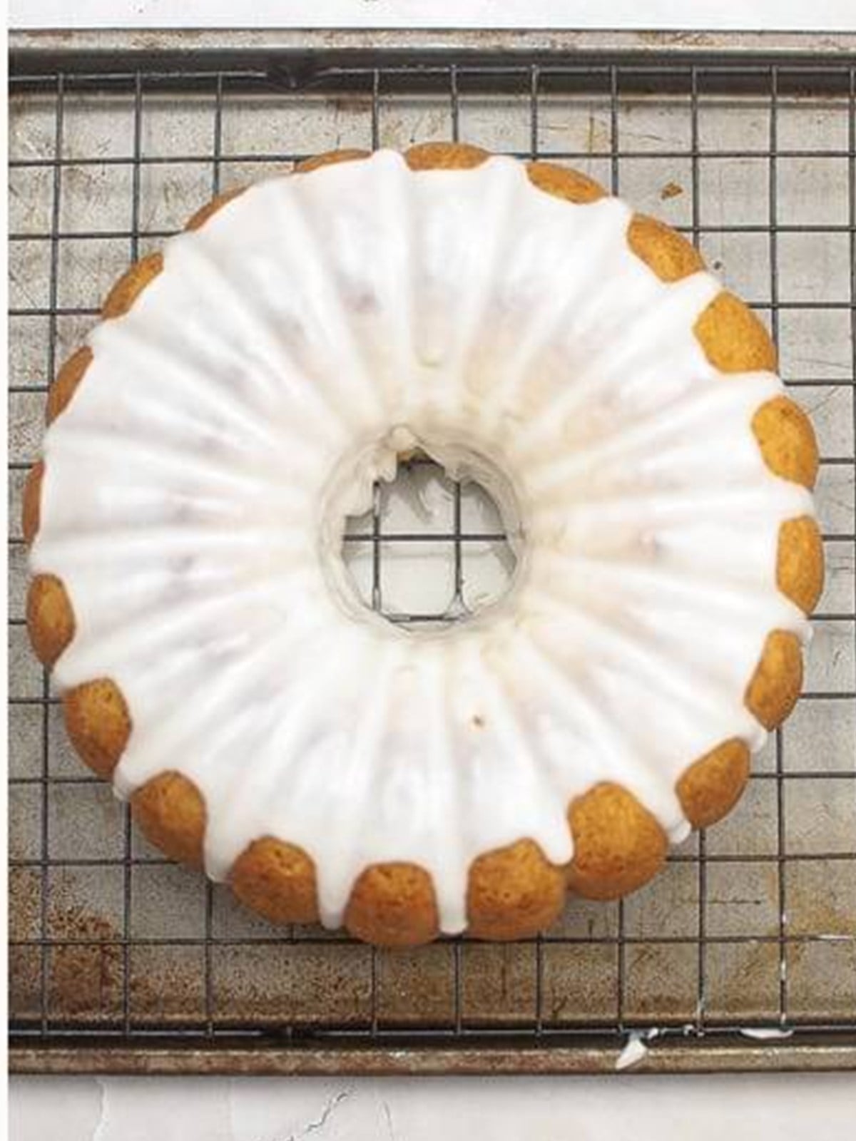 Glazed lemon bundt cake on a wire rack.