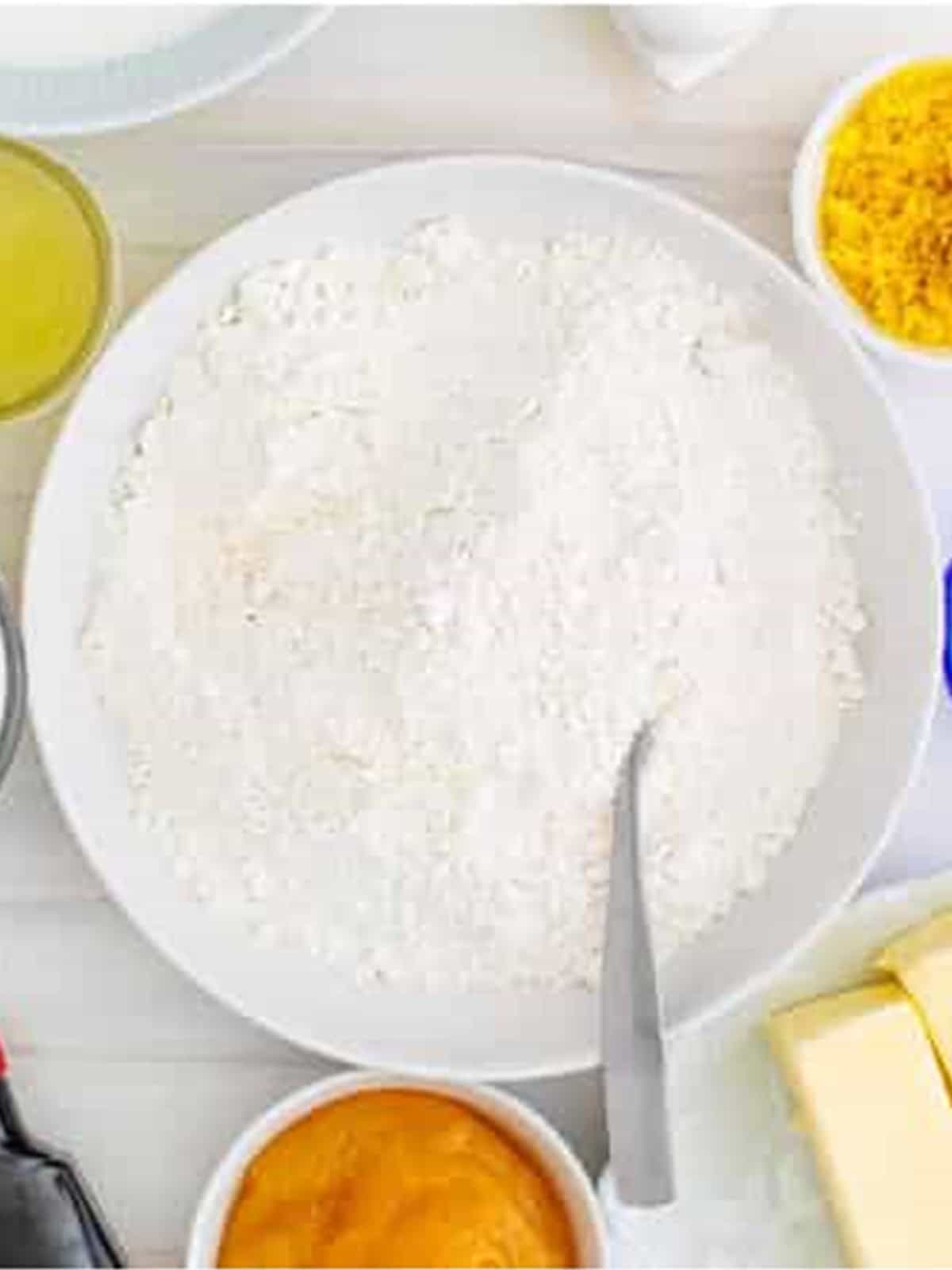 Cake flour, baking powder, and salt on a plate for lemon cake.