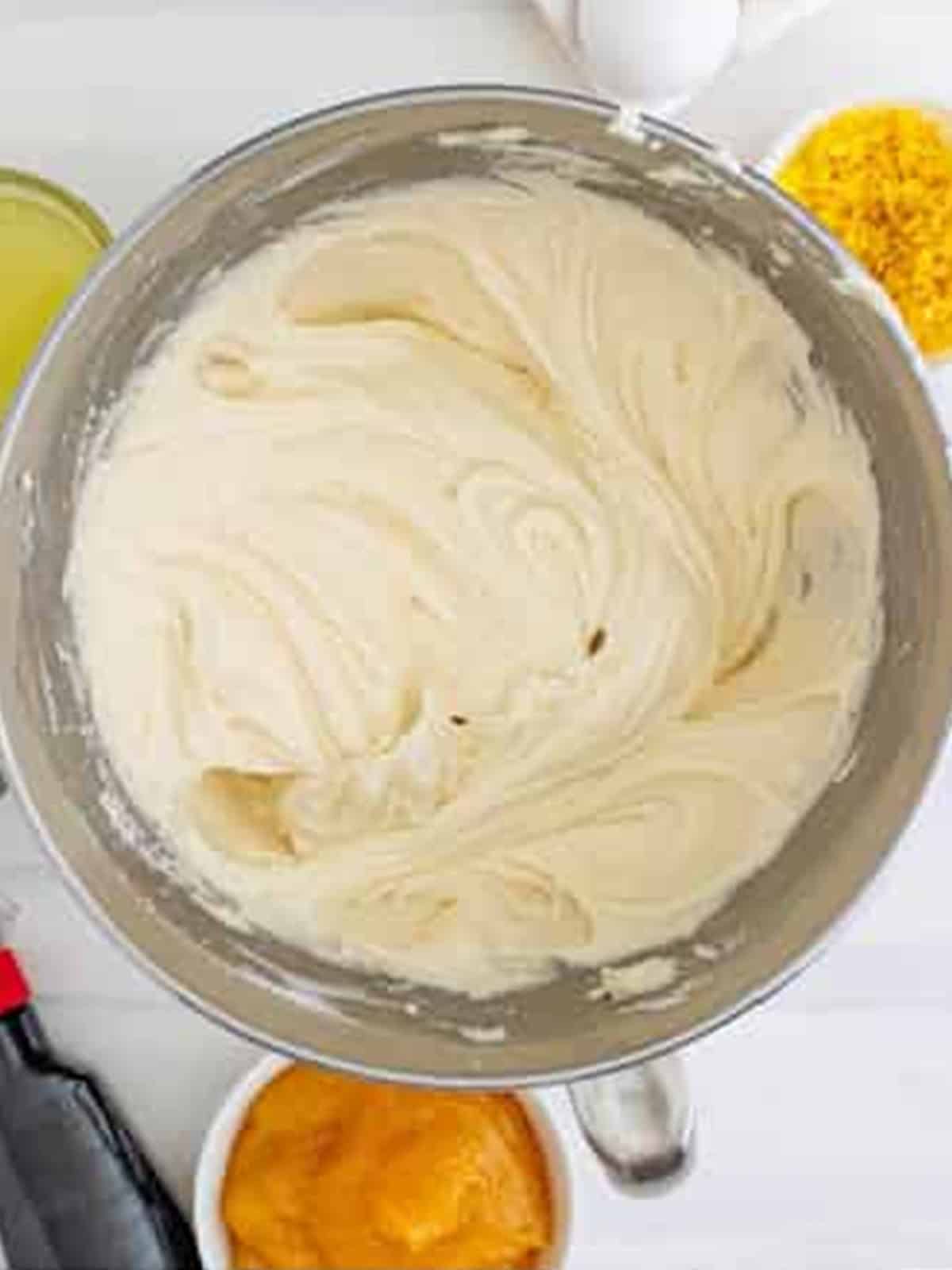 Lemon buttercream frosting whipped until light and fluffy in a mixing bowl.
