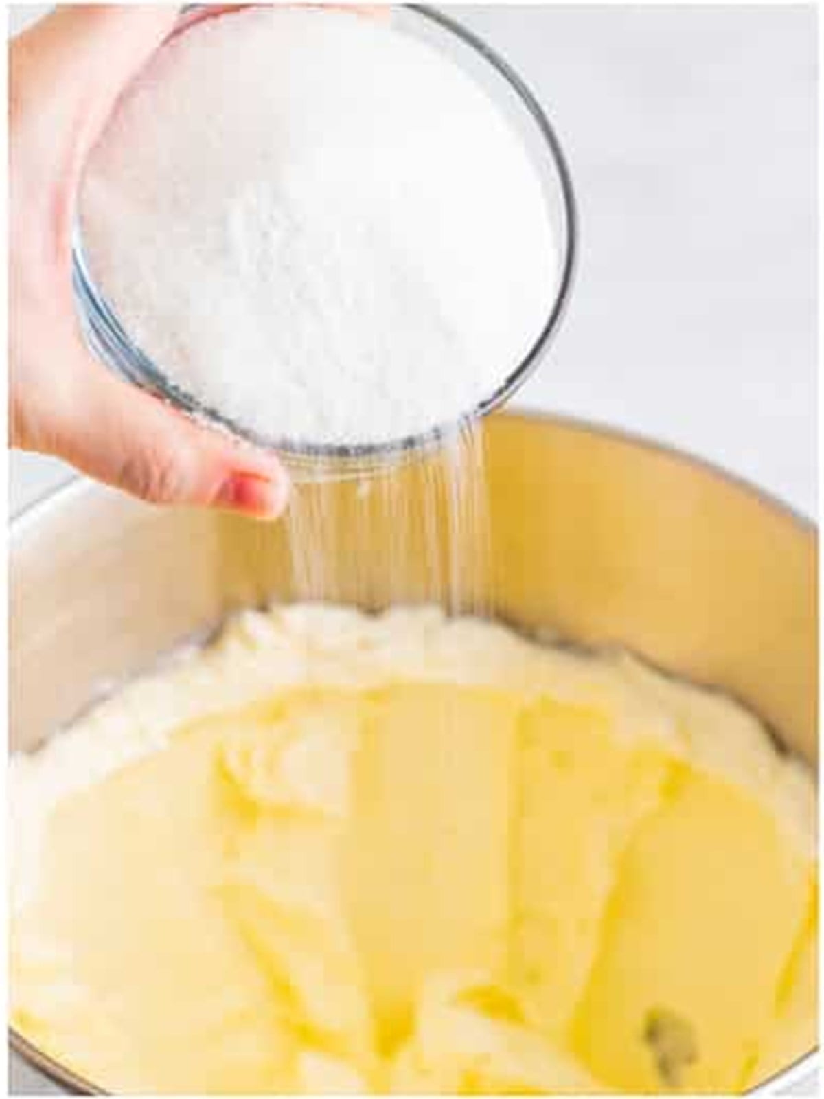 Beating cream cheese and sugar in a stand mixer for the Lemon Cheesecake filling.