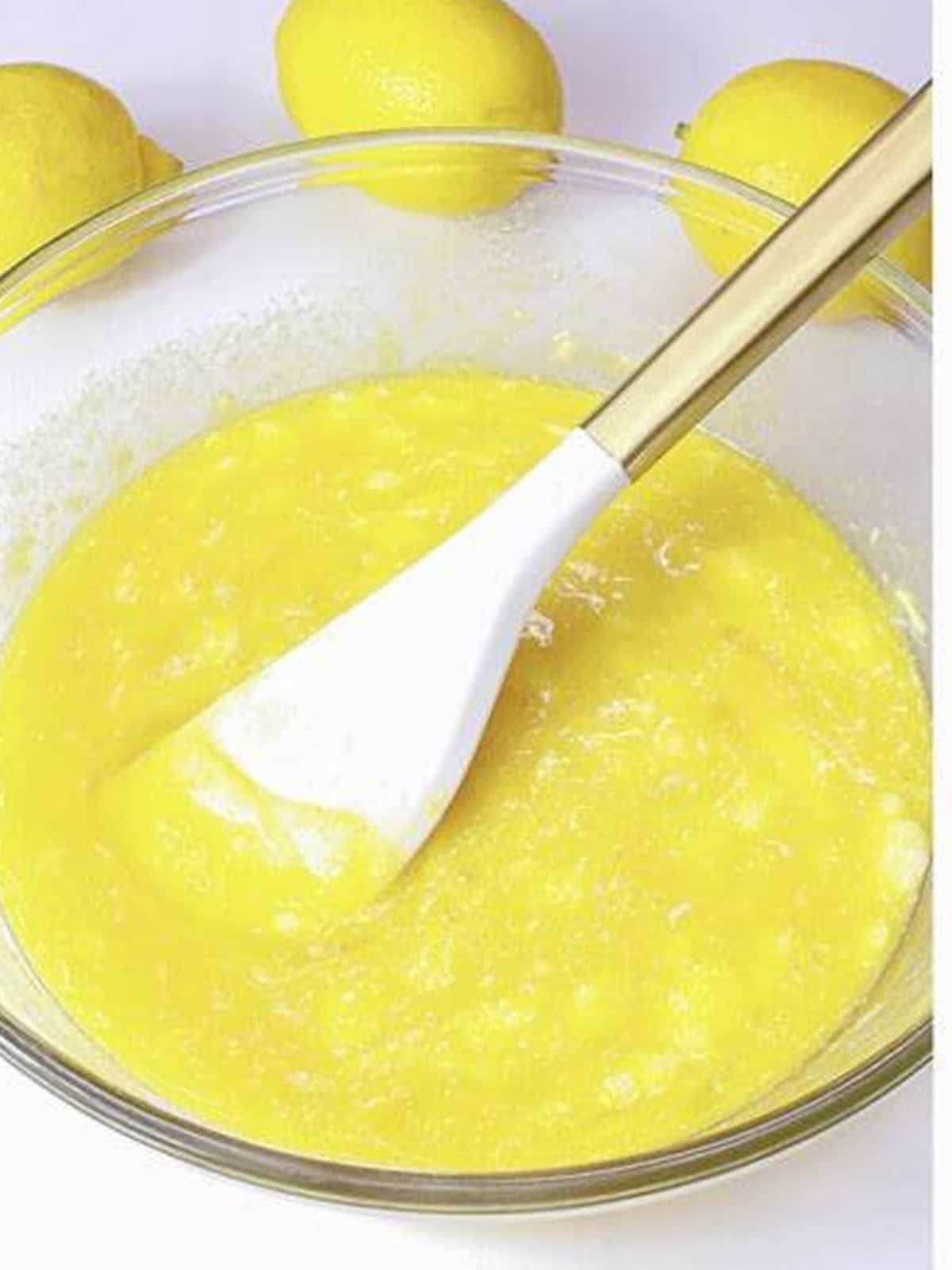 Lemon cupcake batter being mixed in a glass bowl.