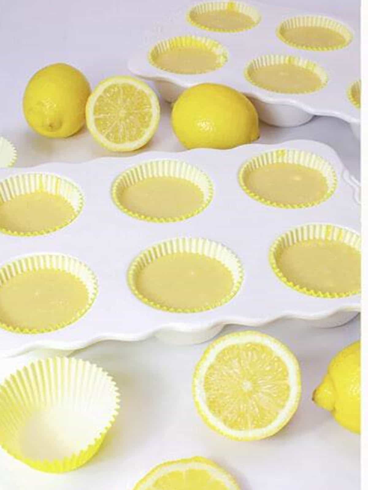 Lemon cupcake batter filled into a muffin pan with paper liners.