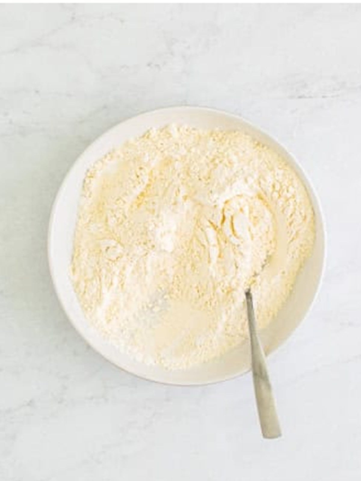 Whisking together flour, baking powder, salt, and baking soda for lemon cupcakes.
