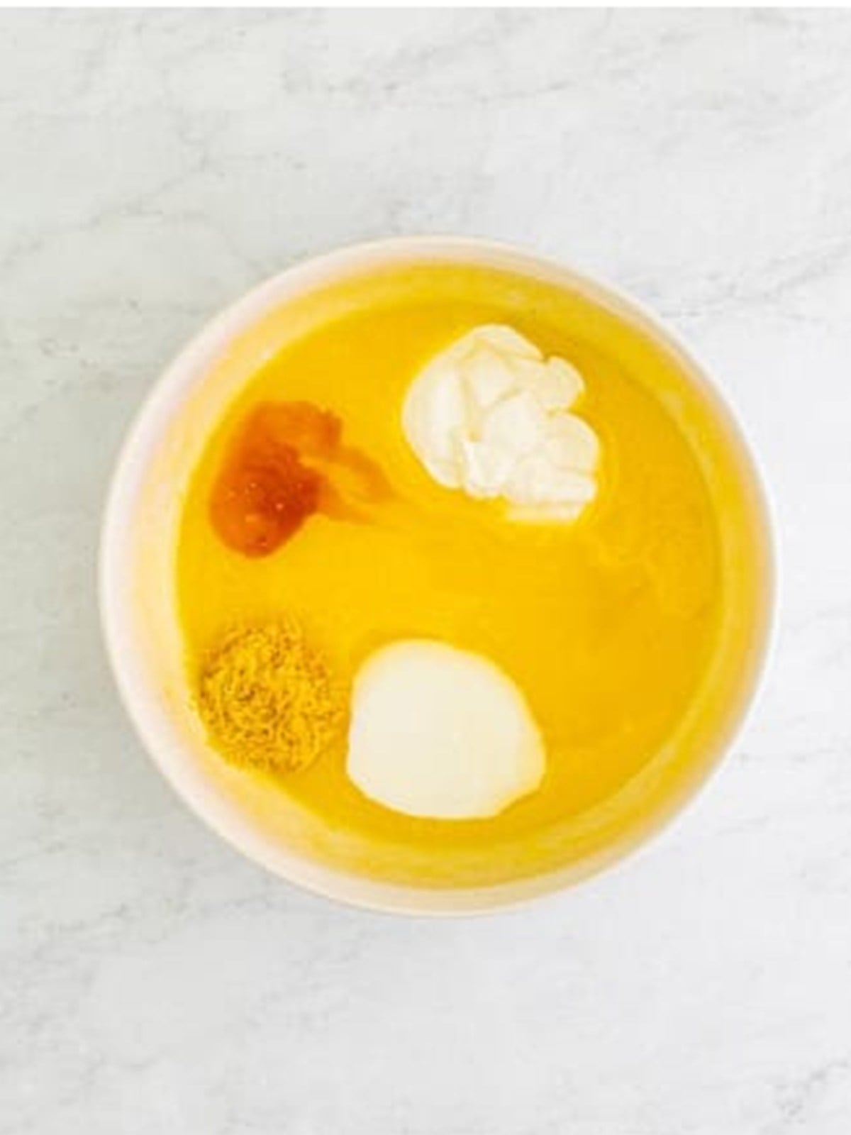 Adding sour cream, buttermilk, lemon juice, and zest to the batter.