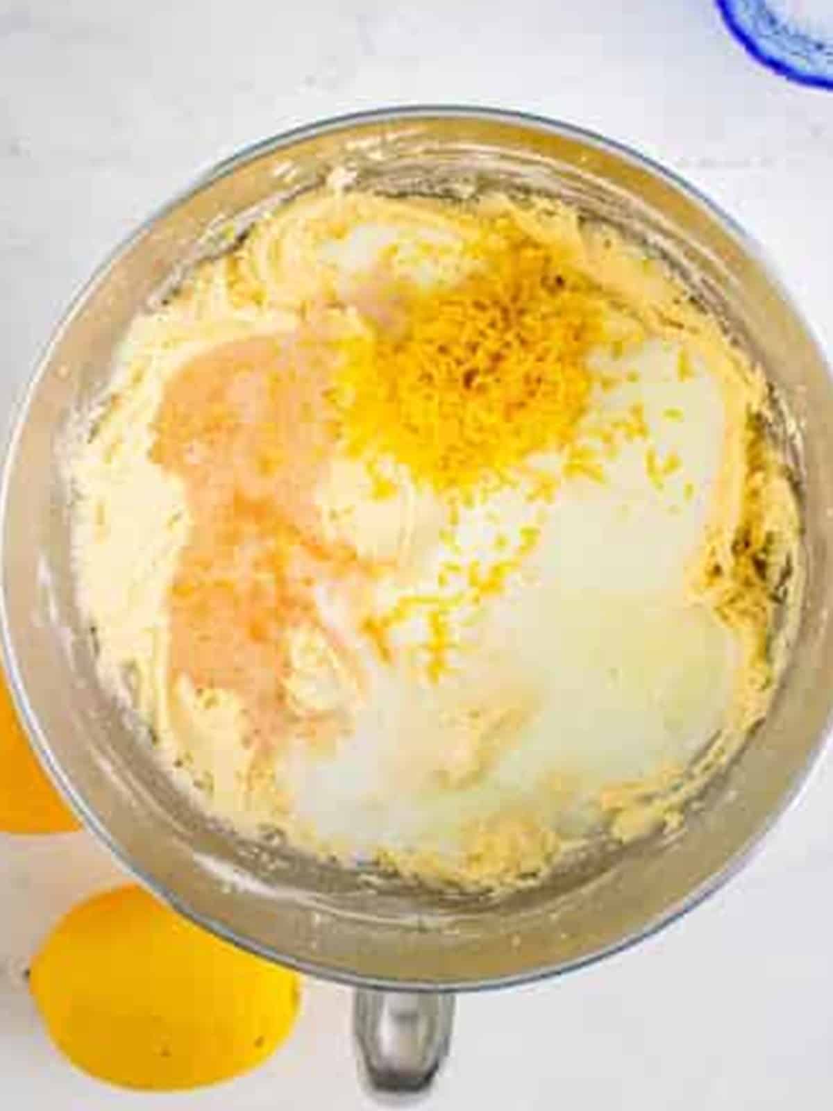 Adding milk, lemon juice, and zest to the cake batter.