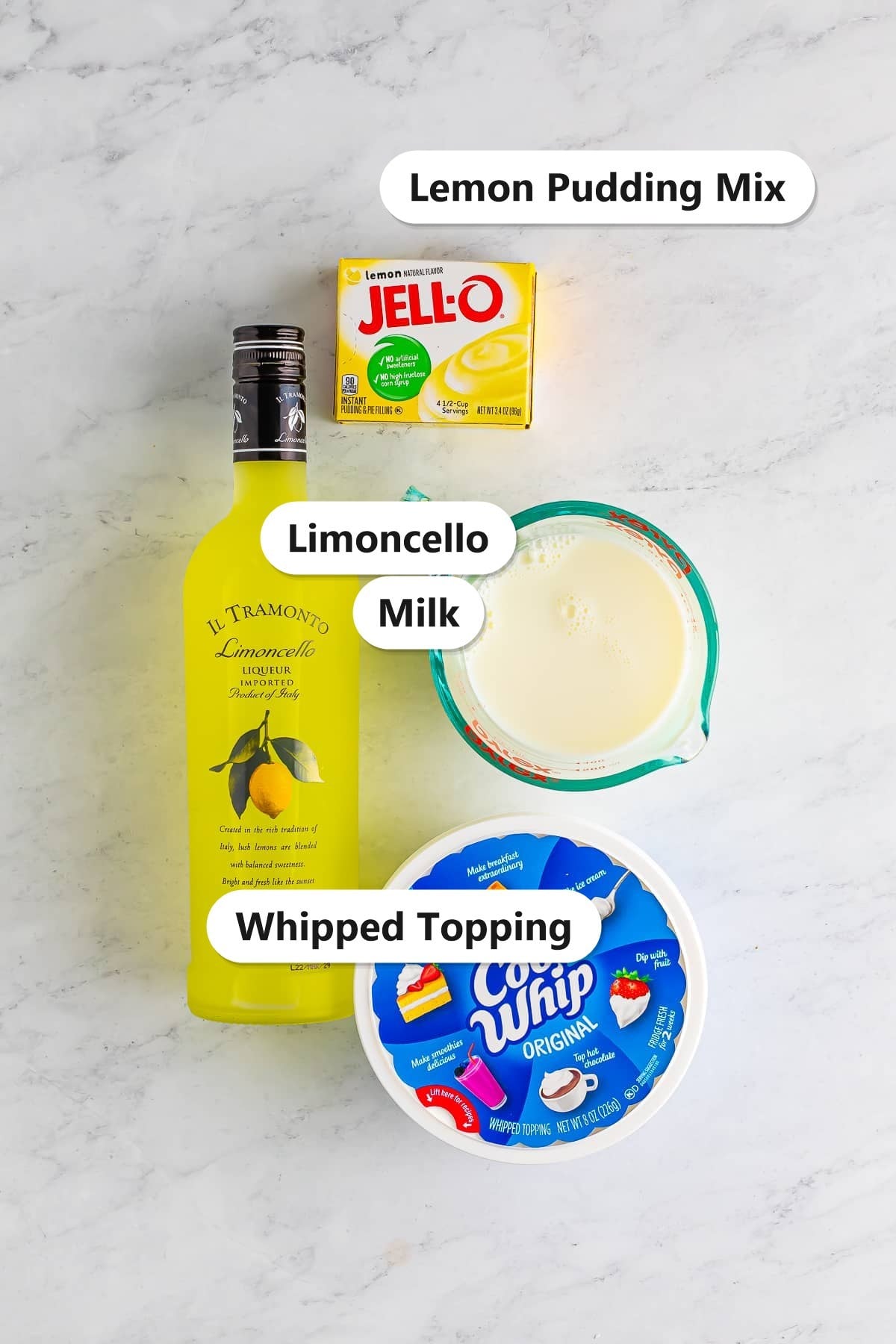 Labeled ingredients for lemon pudding shots including instant lemon pudding mix, limoncello, milk, and whipped topping.