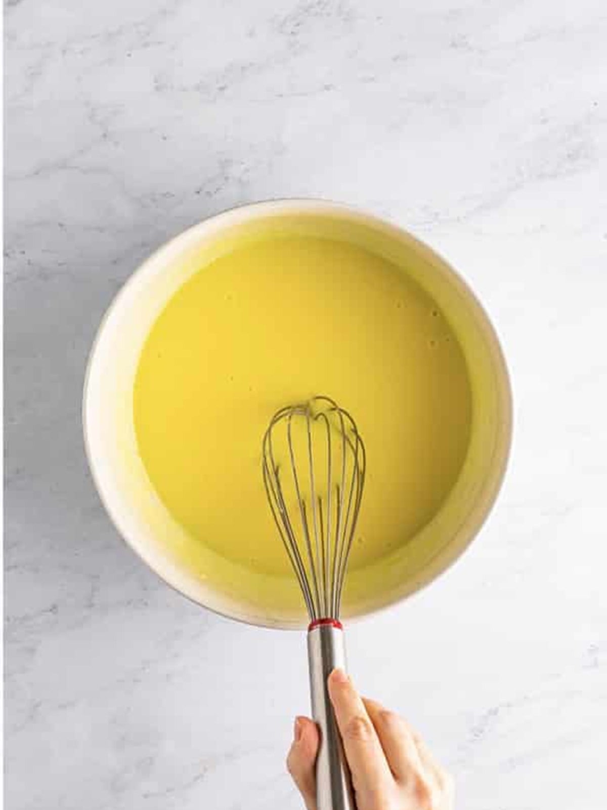 Limoncello whisked into the lemon pudding mixture until it begins to thicken.
