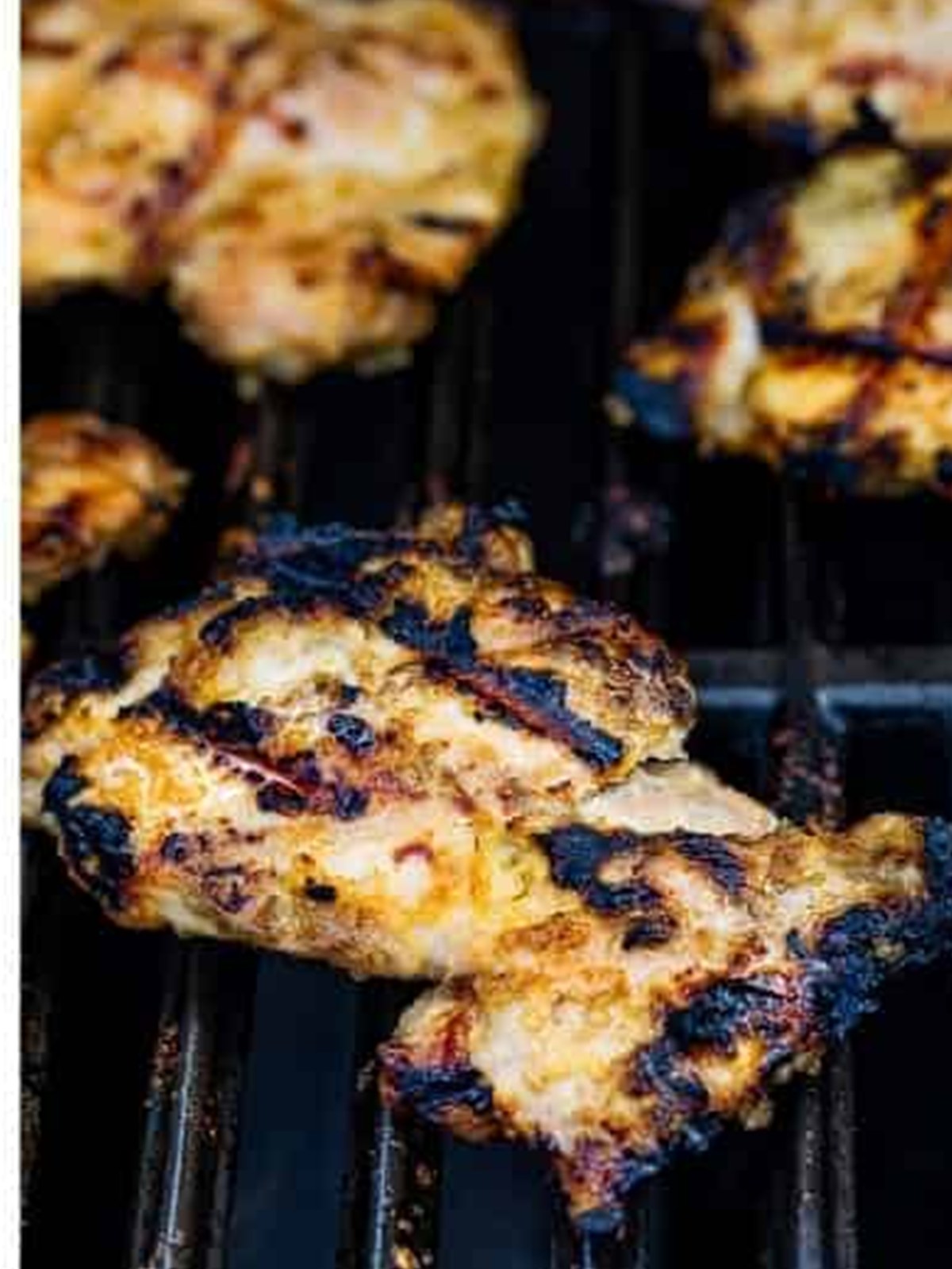 Grilled lemongrass chicken thighs cooking on the grill.