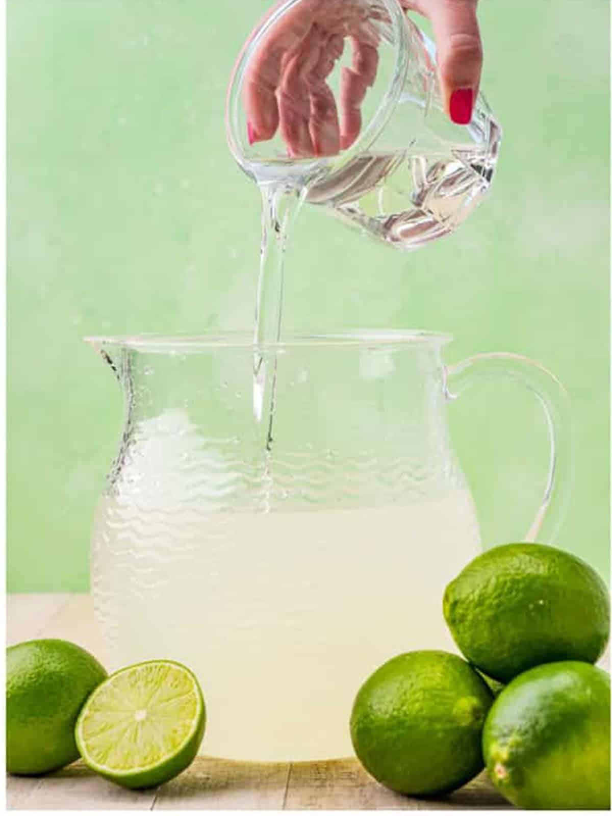 A pitcher of freshly made limeade stirred together with ice.
