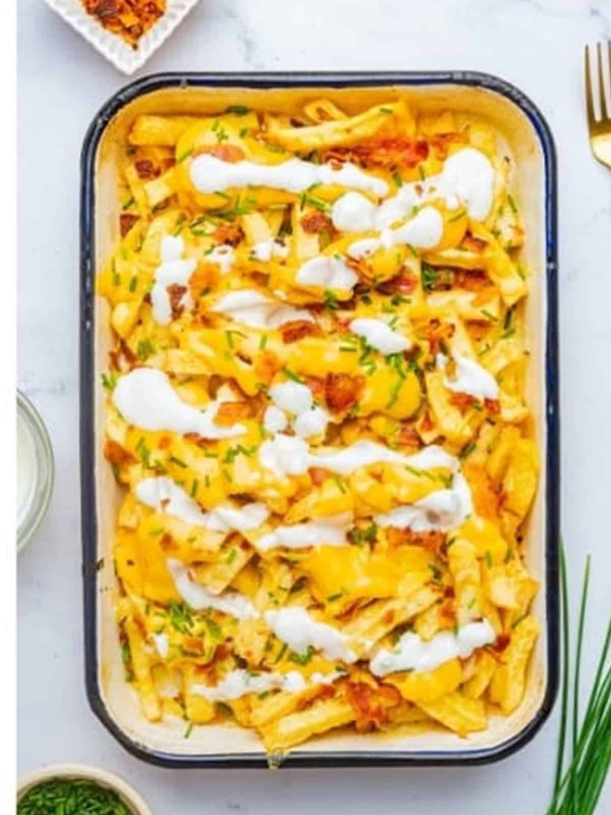 Loaded fries with melted cheese and bacon fresh from the oven.