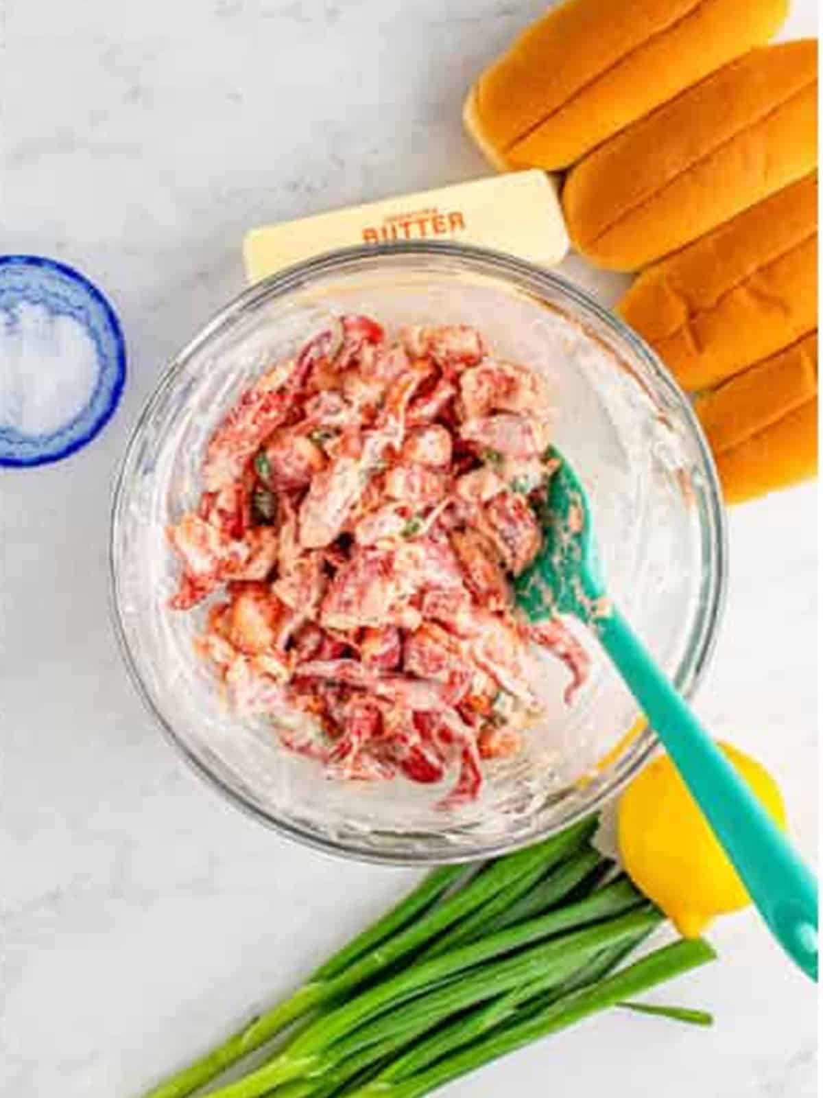 Cooked lobster meat folded into the creamy dressing for lobster rolls.