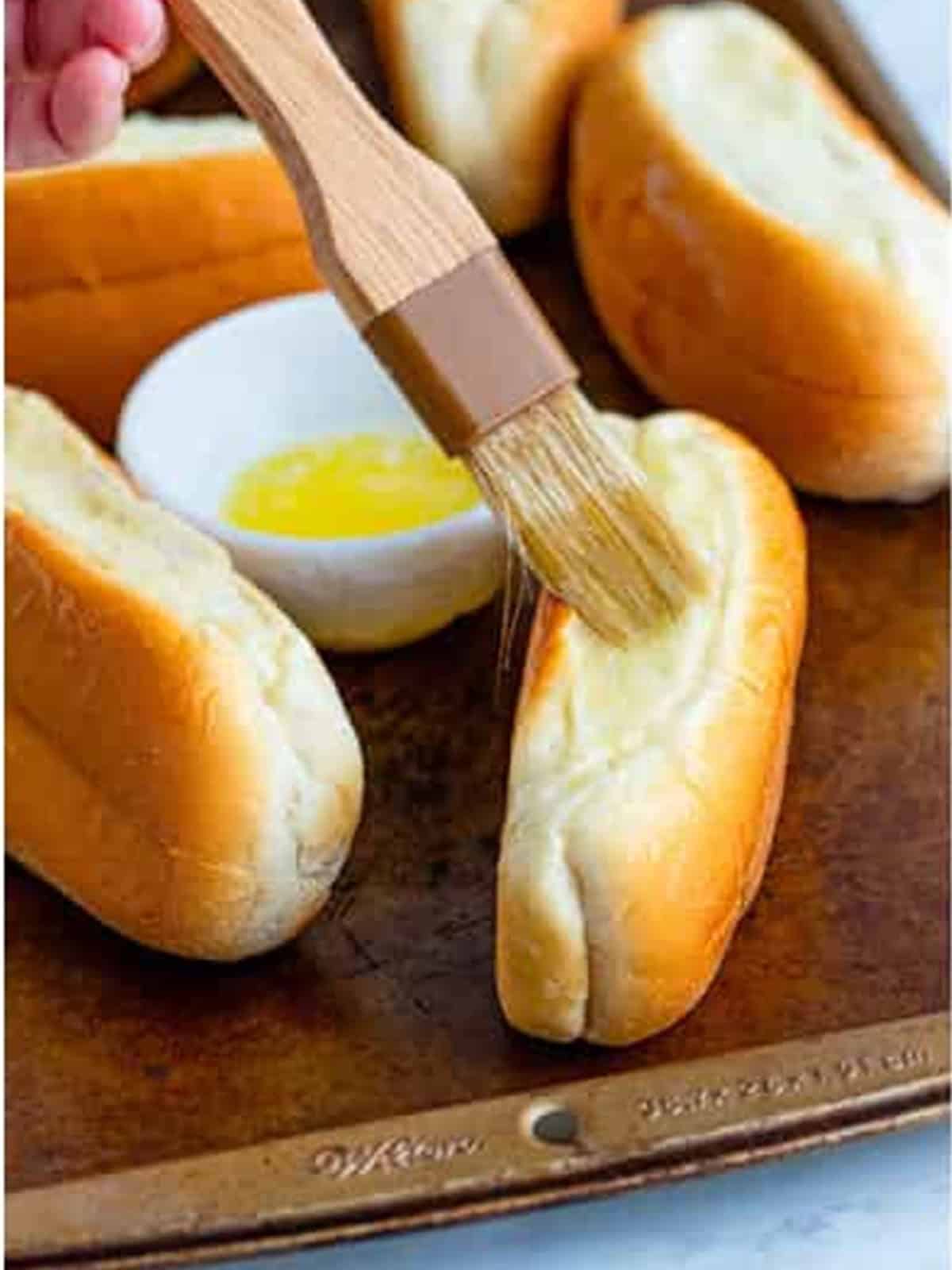 Split top hot dog buns brushed with melted butter.