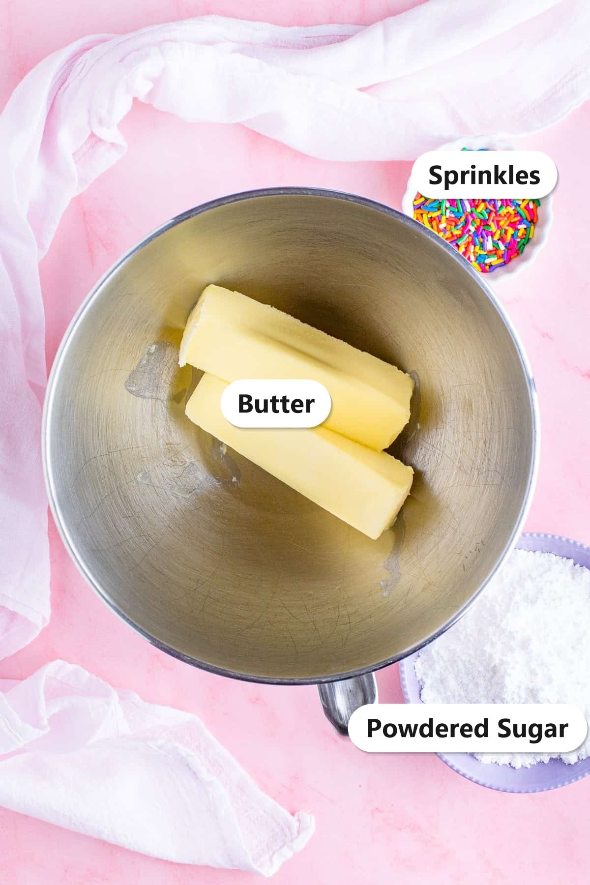 Labeled ingredients for soft frosted lofthouse cookies including butter, powdered sugar, and rainbow sprinkles.