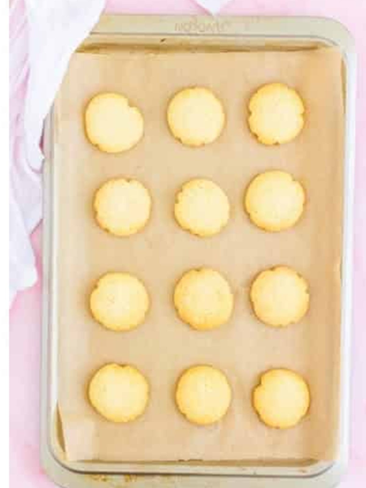 Baked lofthouse cookies with pale golden edges cooling on the tray.