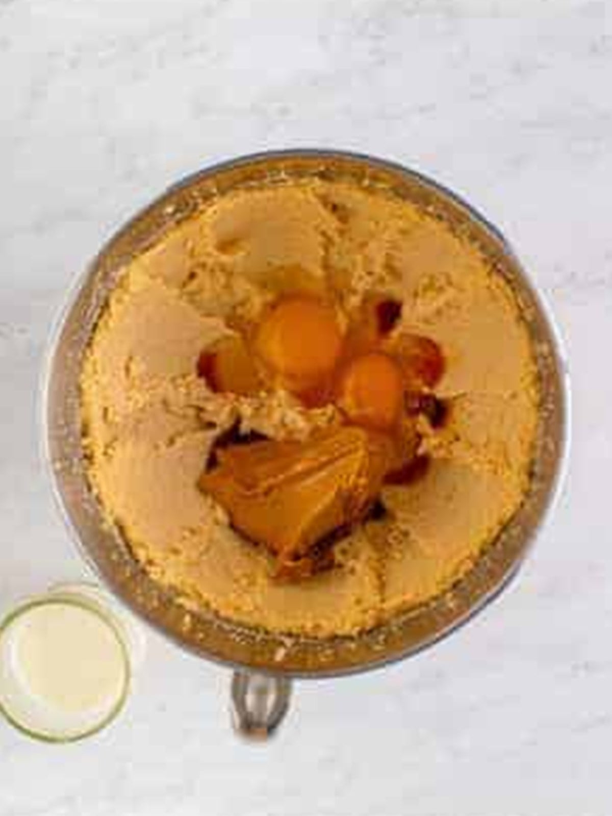 Peanut butter, eggs, and vanilla added to the creamed butter and sugar.