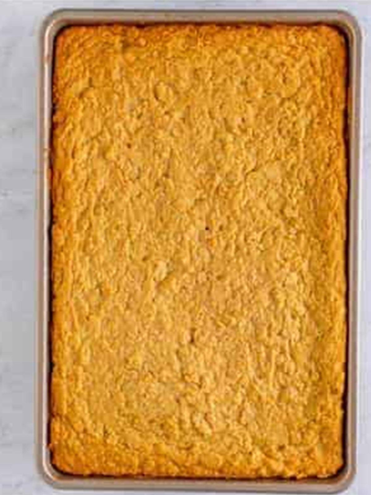 Peanut butter bar dough pressed into a pan and baked until golden.