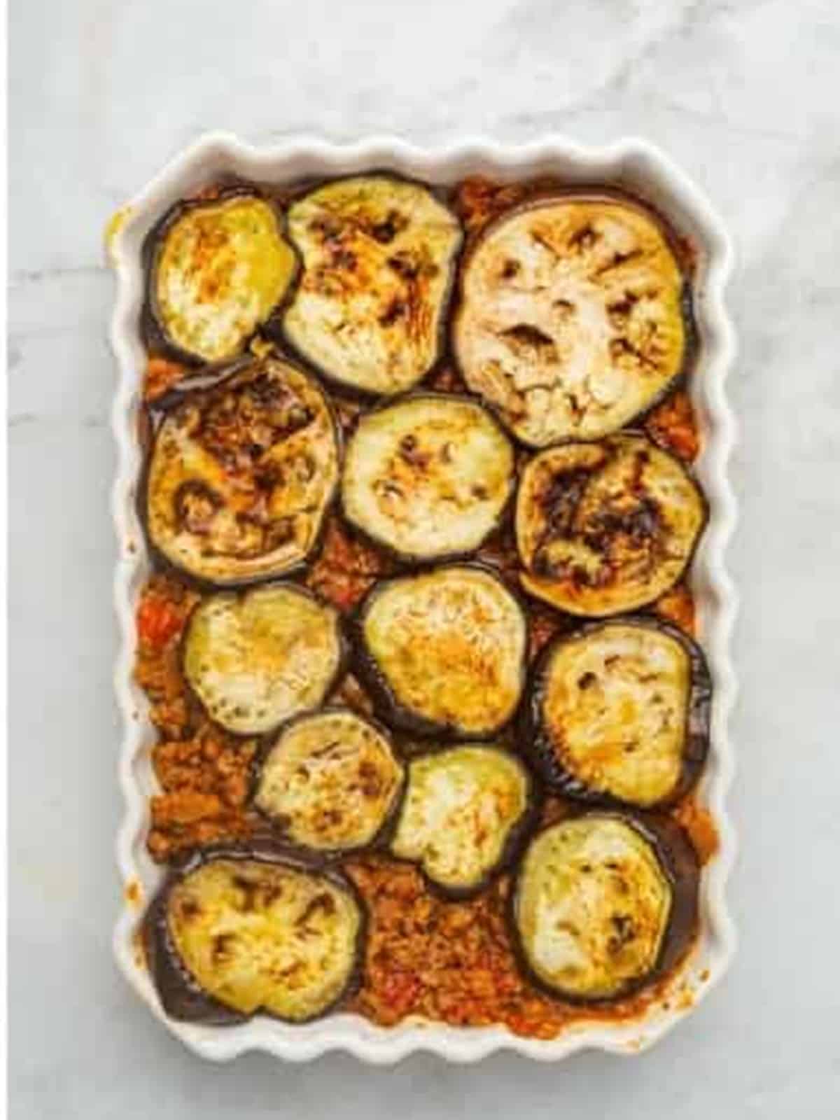 A second layer of grilled eggplant over the meat sauce for moussaka.
