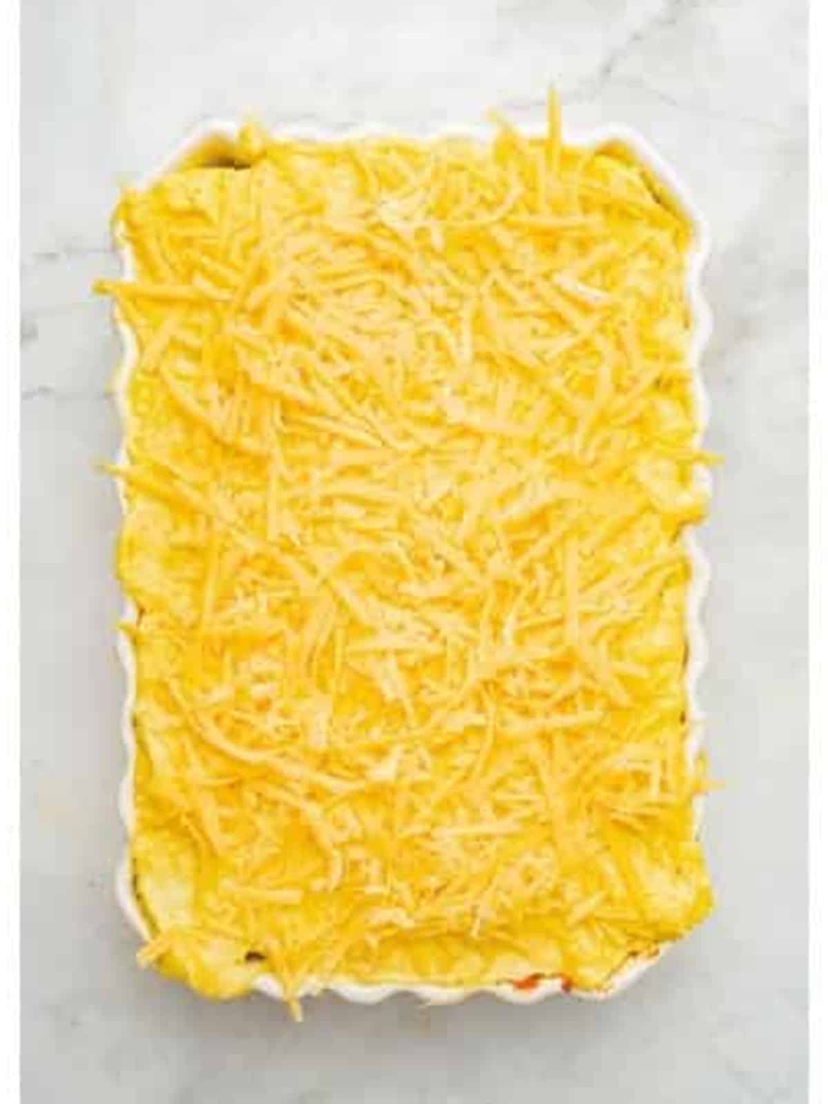 Grated cheese sprinkled over the bechamel topping before baking.