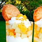 Fresh mango and melon fruit layered with whipped cream for an easy mango dessert verrine.