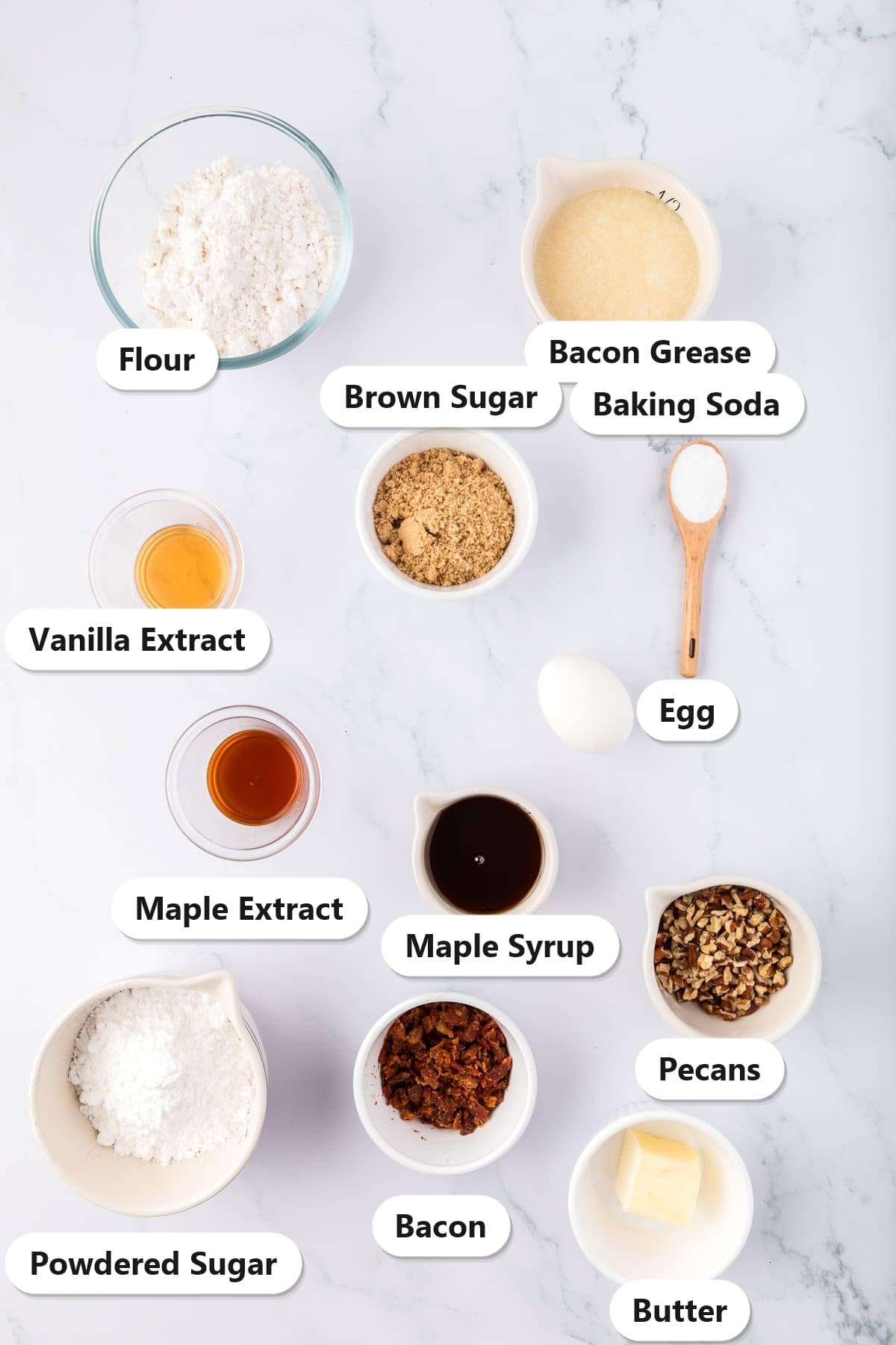 Labeled ingredients for maple bacon cookies including flour, bacon grease, brown sugar, maple syrup, maple extract, pecans, bacon, and butter.