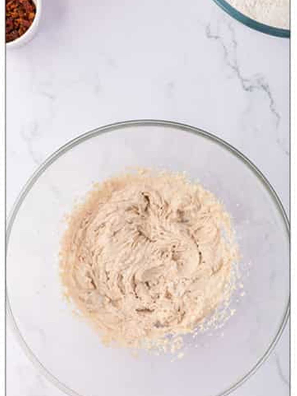 Flour and baking soda whisked together in a glass bowl.