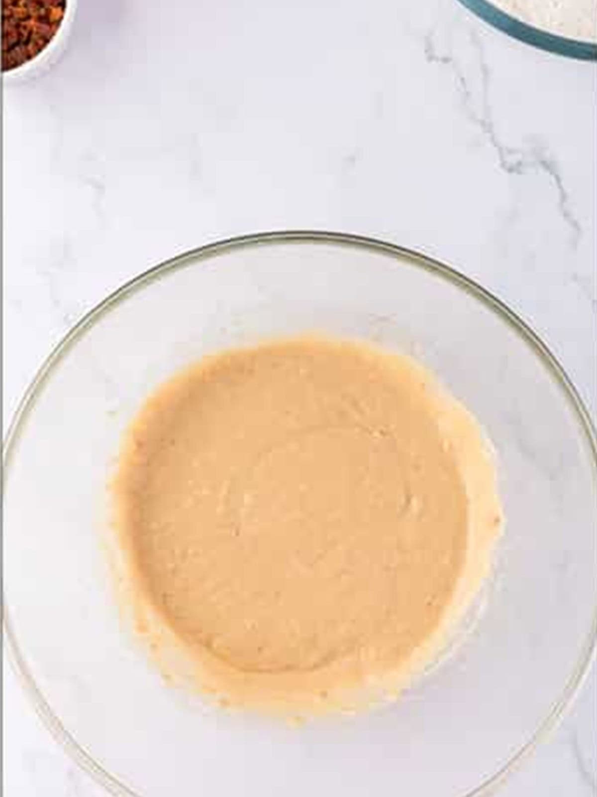 Bacon grease, brown sugar, egg, and maple syrup creamed together in a bowl.