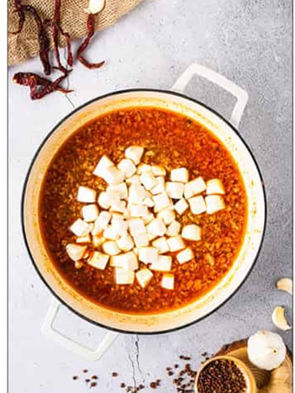 Soft tofu cubes added to the simmering Mapo Tofu sauce.