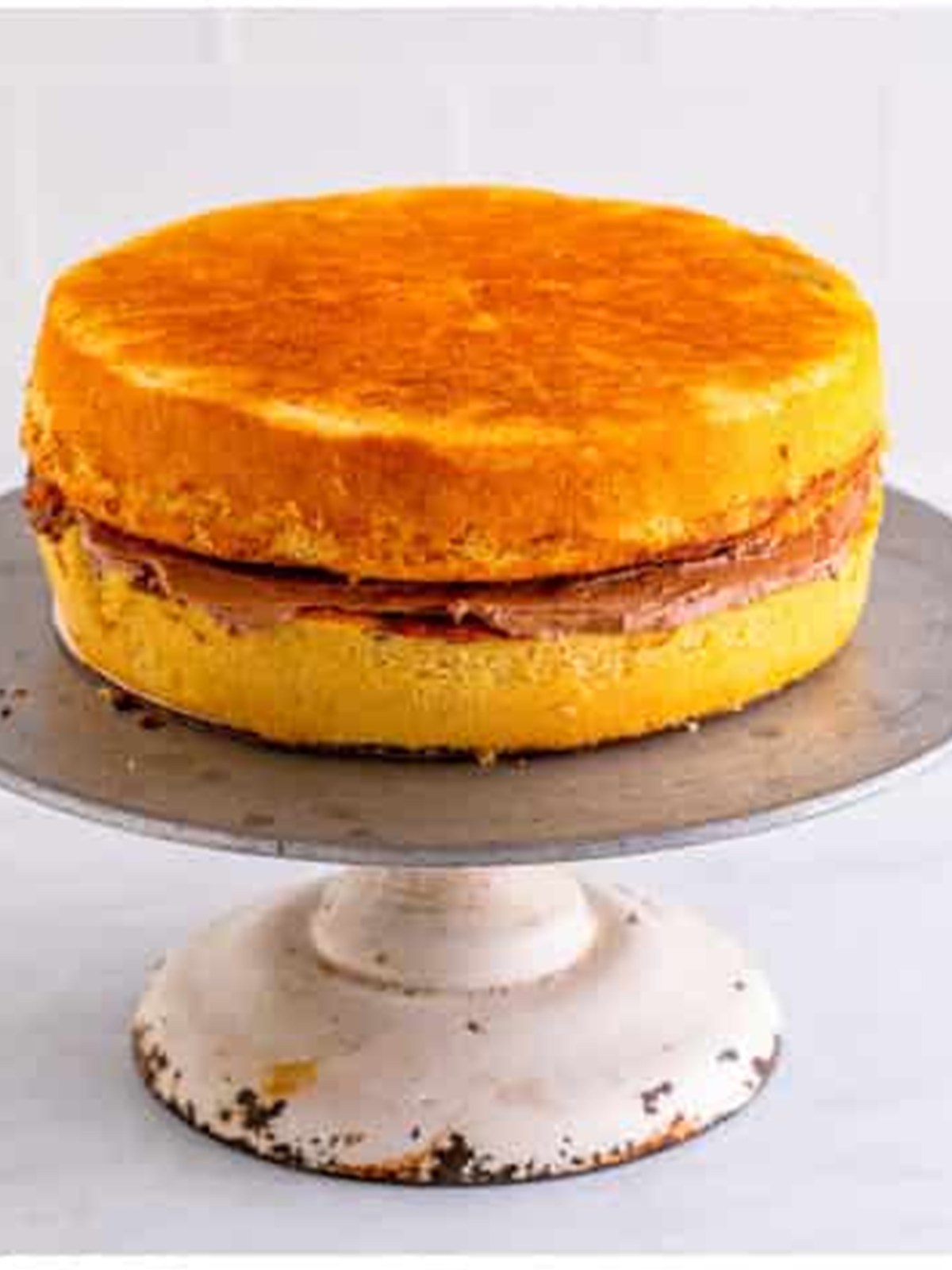 Marble cake layers stacked with chocolate frosting