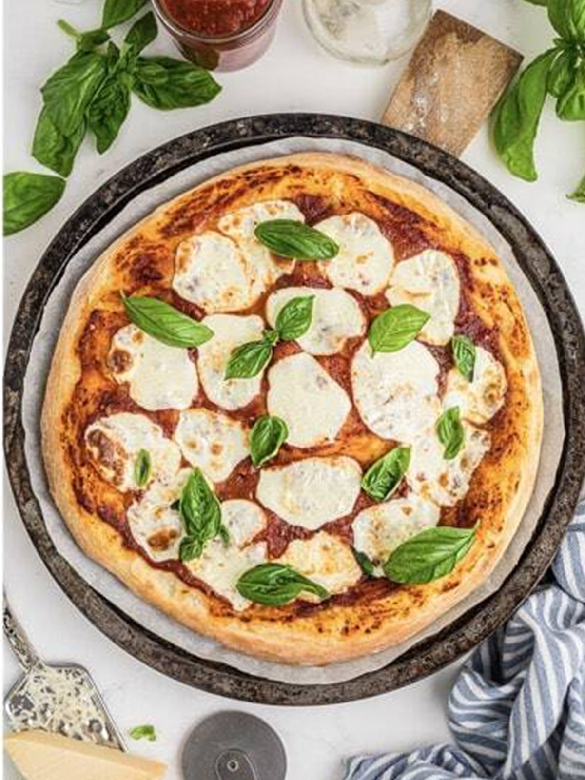 Margherita pizza topped with fresh basil leaves