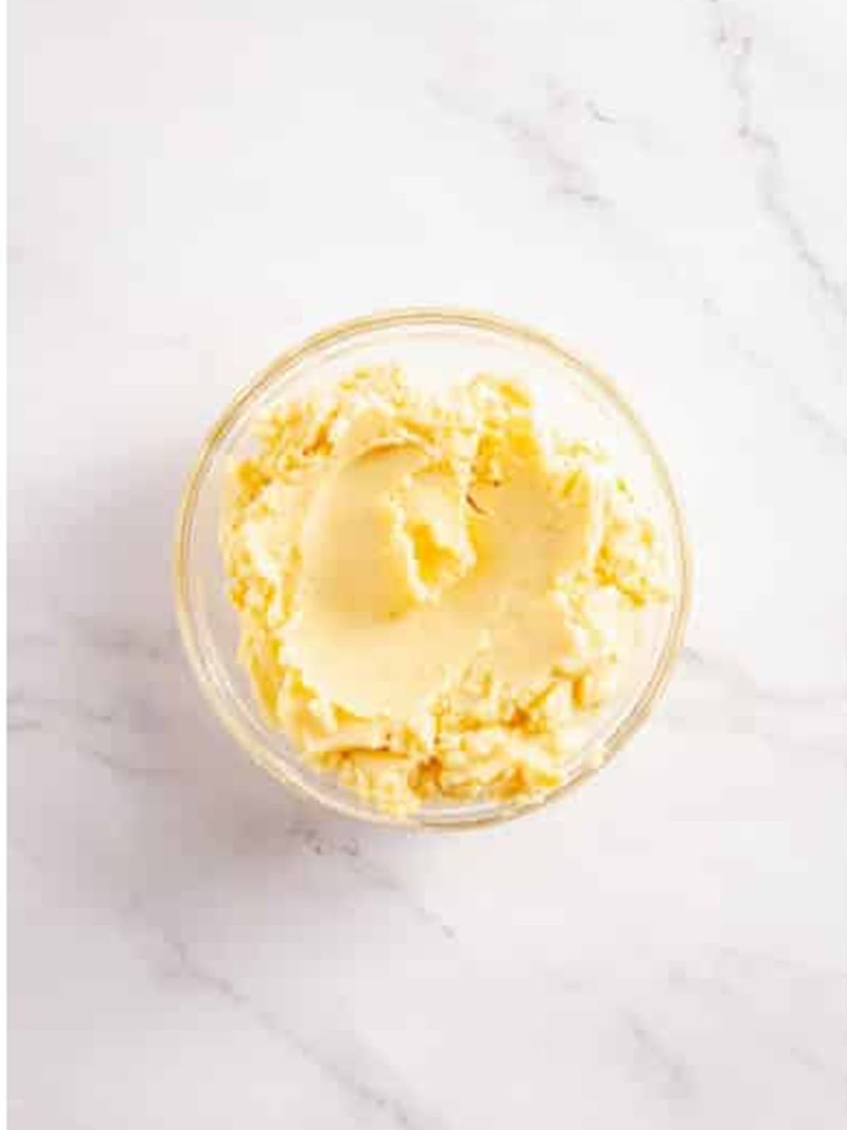 Instant mashed potatoes mixed with water in a glass bowl for mashed potato cakes.